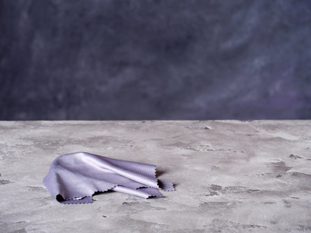 Gray cloth for cleaning lies on a concrete surfaceの写真素材