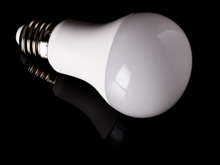 Energy saving LED light bulb isolated on a black backgroundの写真素材