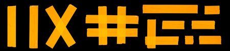 A set of different forms of orange adhesive tape isolated on a black backgroundの写真素材