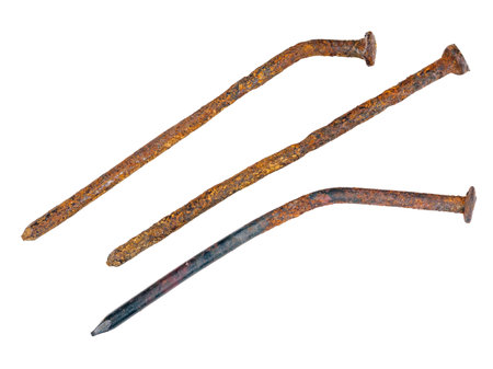 Old used and deformed nails, rusted and oxidized close-up, isolated on a white backgroundの写真素材
