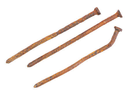 Old deformed and rusted nails close-up, isolated on white backgroundの写真素材