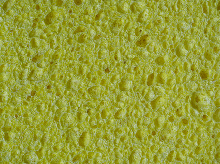 Dishwashing sponge texture, abstract yellow backgroundの写真素材