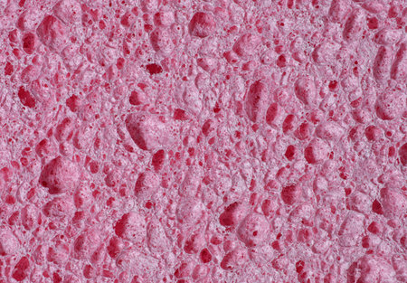 Texture of a porous pink sponge in close-up as an abstract backgroundの写真素材
