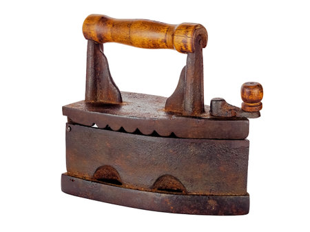 An old rusty smoothing iron close-up isolated on a white backgroundの写真素材