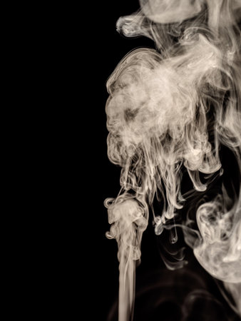 White smoke jet rises isolated on a black backgroundの写真素材