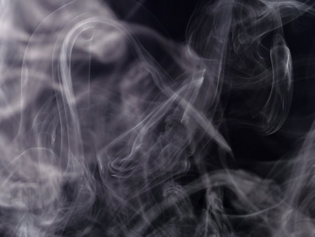 Abstract white smoke jets on black backgroundの写真素材