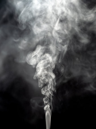 Steam smoke isolated on a black background as fog or steam textureの写真素材
