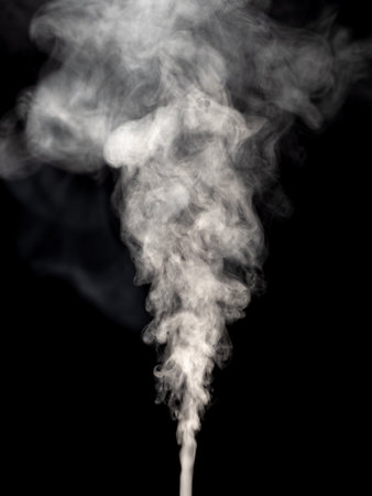 Steam or abstract white smog isolated on a black background rising upwardの写真素材