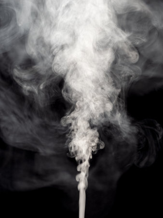 Jet of white smoke steam or abstract white smog isolated on a black background and rising upの写真素材