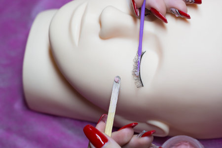 training a young master to build eyelashes on a silicone mannequin. Work with tweezers, volume...