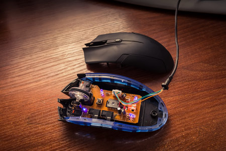 diodes glow on an exploded computer mouse.