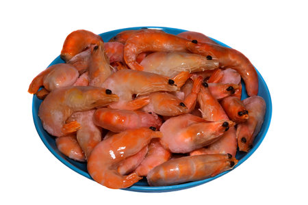 frozen shrimp in icy glaze over white background.