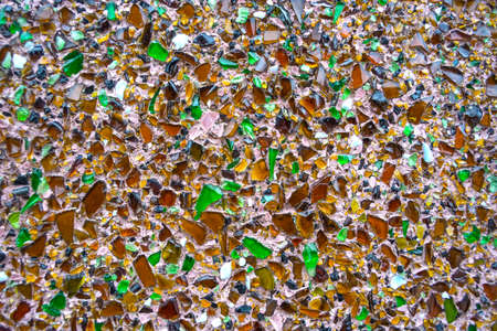 texture of concrete wall covered with shards of multicolored bottle glass.の写真素材