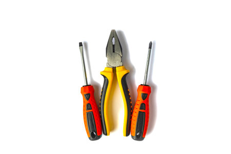 pliers and screwdrivers with rubberized handles on a white background.