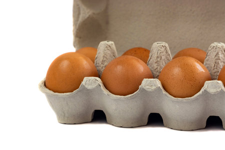 Eggs in paper tray isolated on white