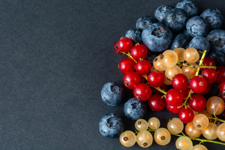 berries of red and white currants and blueberries in plastic packaging