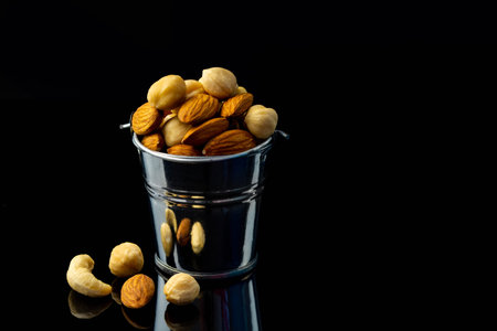 Mix of nuts in a small iron bucket and a shopping basket.