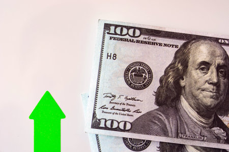 green up arrow near dollar bills. rate growth concept.