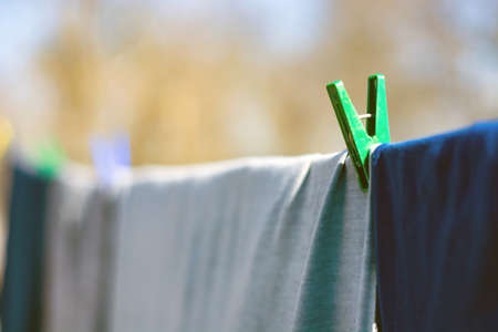 clothes hitched with clothespins weigh on a rope.の写真素材