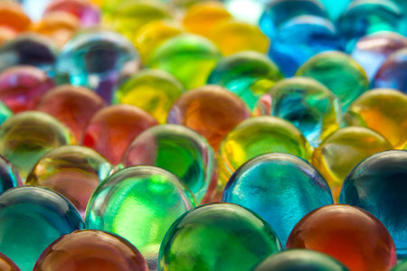 Water coloured gel balls. Silica gel. Crystal liquid ball with reflection. Texture background. Close...