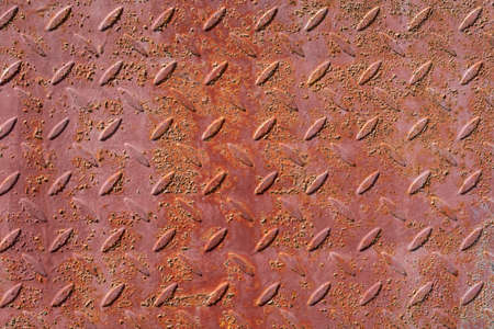 background of old, rusty iron sheet with notches.の写真素材