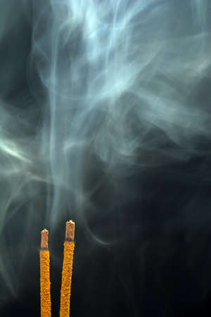 smoking flavored sticks on a black background.の写真素材