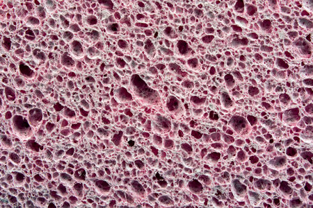 texture of an old pink washcloth with backlight.