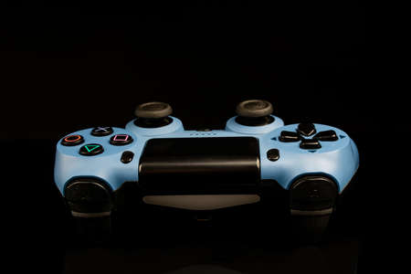 a blue joystick from a game console on a black background.の写真素材