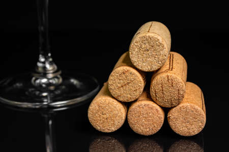 red wine in a glass on a high leg on a black background.の写真素材