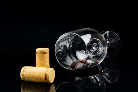 red wine in a glass on a high leg on a black background.の写真素材