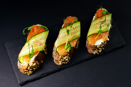 fresh bruschetta with shrimp, cheese, ham and microgreens.の写真素材