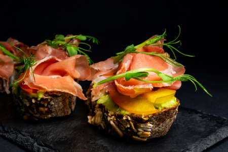 fresh bruschetta with shrimp, cheese, ham and microgreens.の写真素材