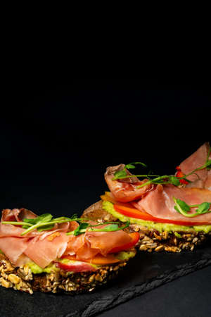 fresh bruschetta with shrimp, cheese, ham and microgreens.の写真素材