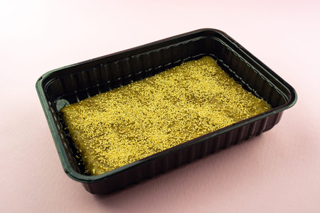microgreen seeds in a container on a linen mat.