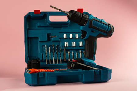 case with a screwdriver and nozzles on a pink background.の写真素材