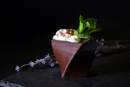cups printed on a 3D printer with chocolate, whipped cream and mint leaves.の写真素材
