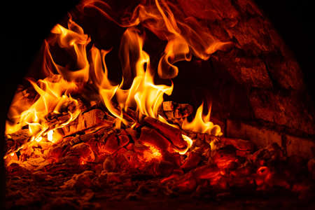 fire in the oven. Firewood is enveloped in flames.の写真素材