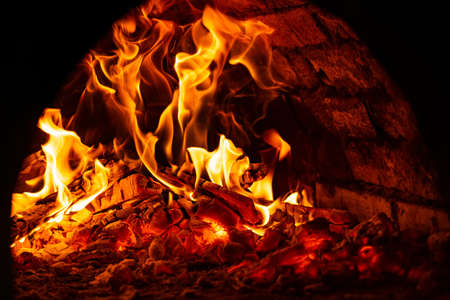 fire in the oven. Firewood is enveloped in flames.の写真素材