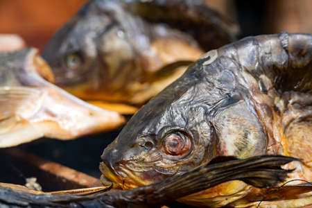 heads of smoke-smoked fish stacked in rows.の写真素材