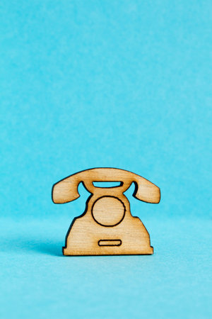 Wooden icon of telephone on blue background verticalの写真素材