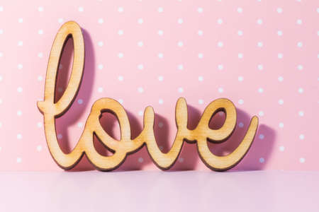 Wooden Love inscription on pink background.の写真素材