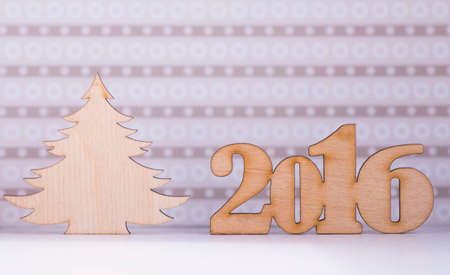 Wooden sign of 2016 year and Christmas tree on lilac background.の写真素材