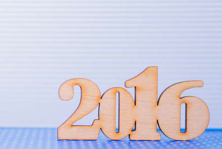 Wooden inscription of 2016 year on light blue background.の写真素材