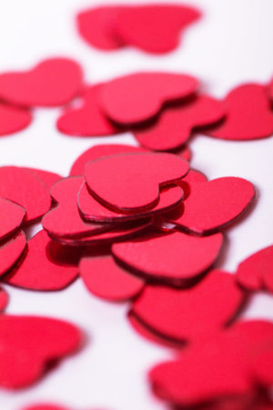 Many red hearts on white background.