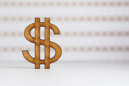 Wooden dollar icon on light spotted background.の写真素材