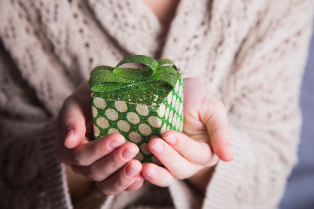 Young female hands holding single gift box.の写真素材