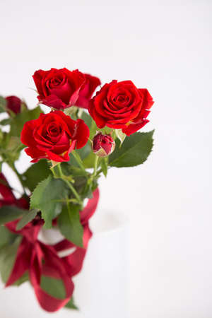 Bouquet of red roses in vase on white background.の写真素材