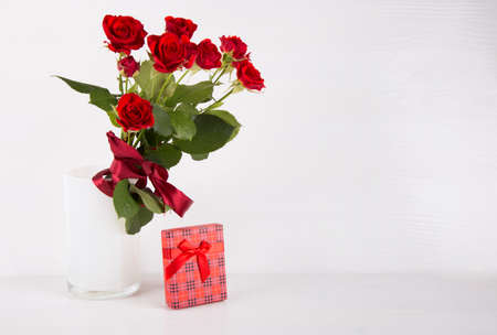 Bouquet of red roses with red gift box on white background.の写真素材