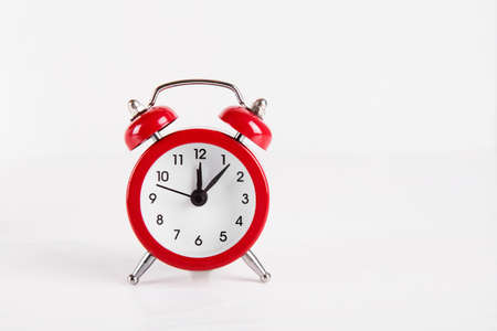 Red little alarm clock on white background.の写真素材