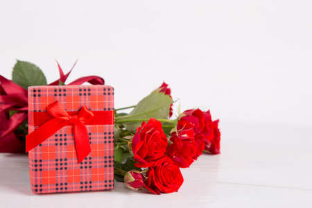 Bouquet of red roses with red gift box on white background.の写真素材